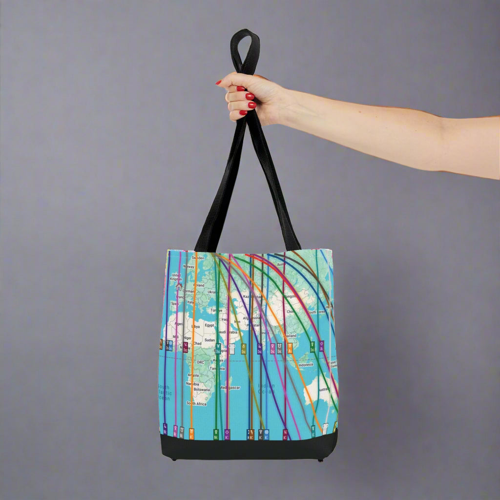 Custom Astrocartography map tote bag with colorful world map design held by a hand in a cute boutique.