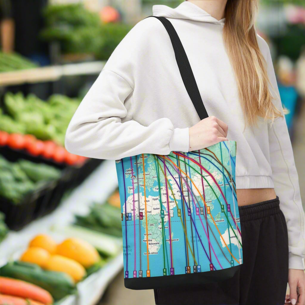 Person holding a colorful astrocartography world map tote bag personalized with their own locational astrology